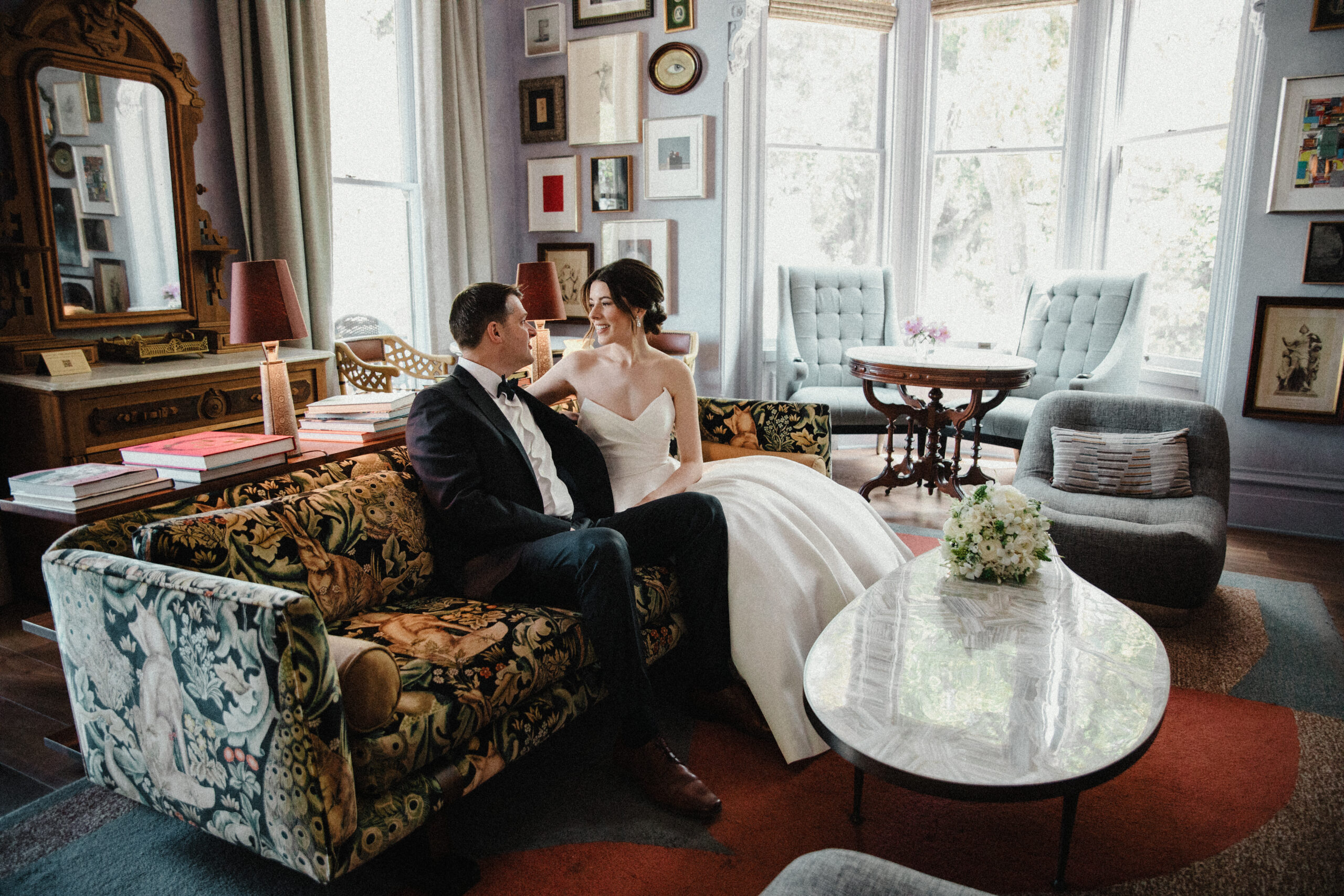 bride and groom sitting in the lounge captured by the madrona hotel wedding photographer